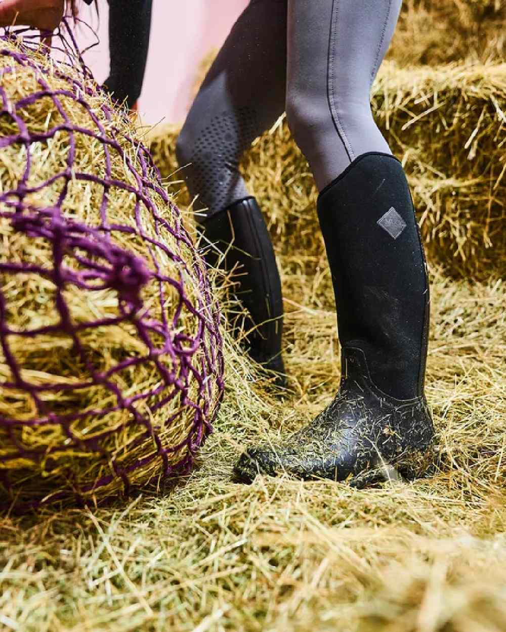 Black Coloured Muck Boots Womens Derby Tall Boots on grass background #colour_black
