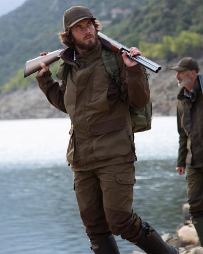 Khaki coloured Percussion Imperlight Reinforced Trousers on coastal background #colour_khaki