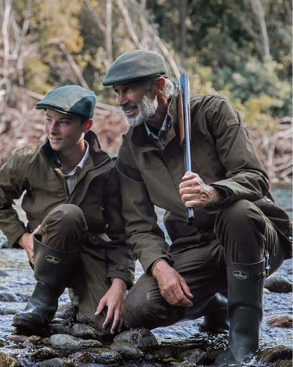 Khaki coloured Percussion Imperlight Reinforced Trousers on riverside background #colour_khaki