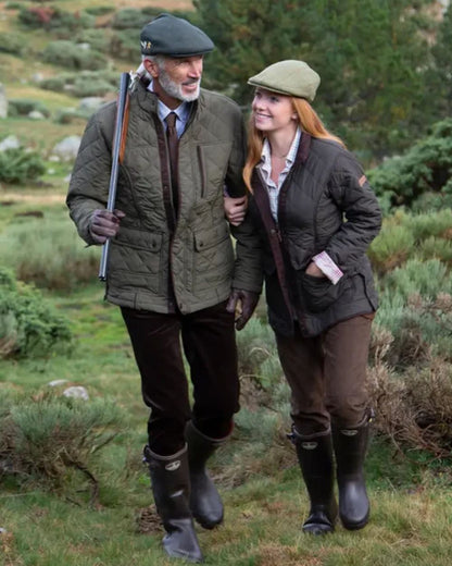 Dark Brown coloured Percussion Stallion Quilted Jacket on forest background #colour_dark-brown