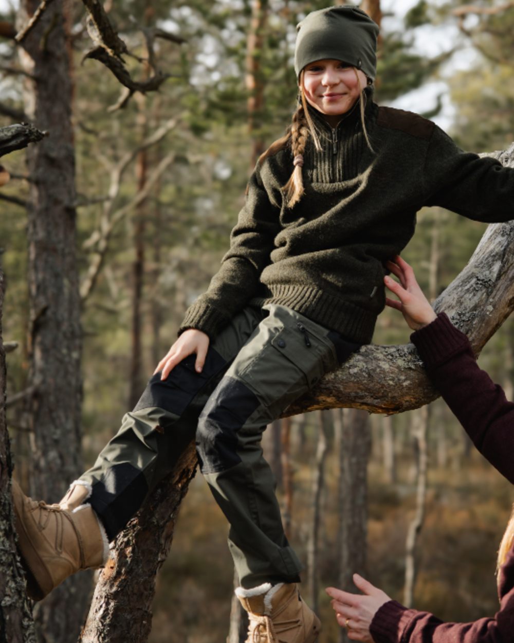 Mid Green Black coloured Pinewood Childrens Lappland Trousers on forest background #colour_mid-green-black