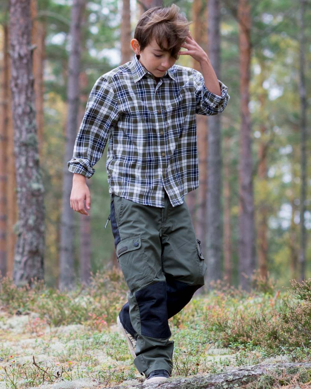 Mid Green Black coloured Pinewood Childrens Lappland Trousers on forest background #colour_mid-green-black