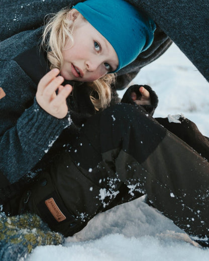 Moss Green Black coloured Pinewood Childrens Lappland Trousers on snow background #colour_moss-green-black