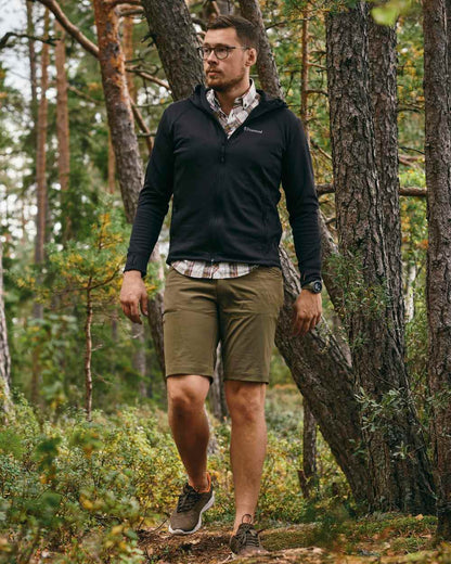 Black Coloured Pinewood Finnveden Hoodie on outdoor background #colour_black