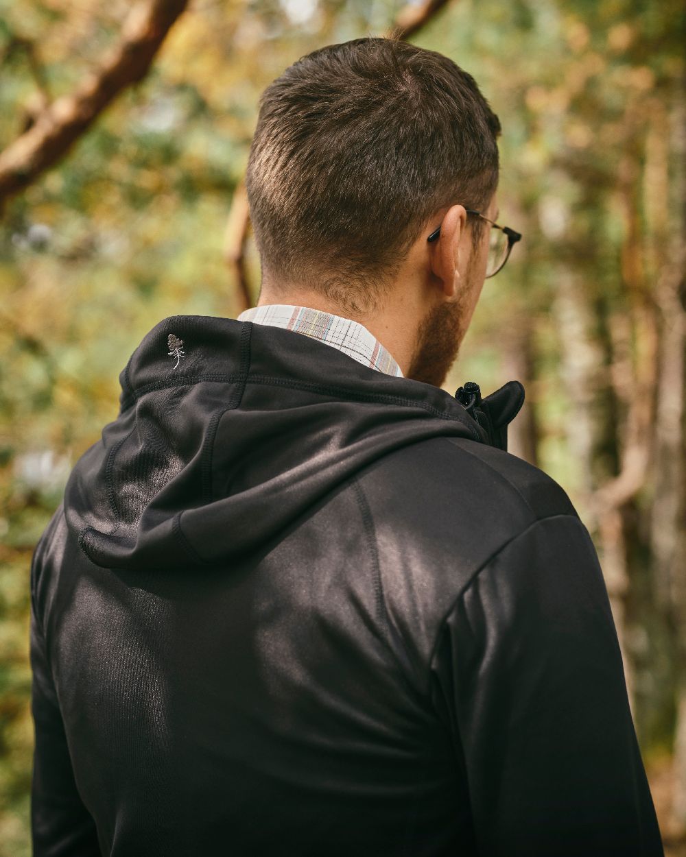 Black Coloured Pinewood Finnveden Hoodie on outdoor background #colour_black