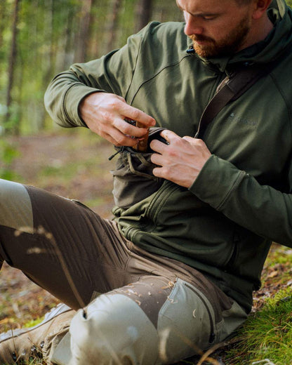 Moss Green Coloured Pinewood Finnveden Hoodie on outdoor background #colour_moss-green