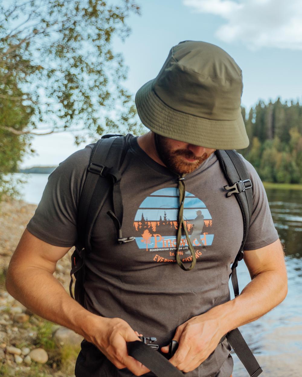 Moss Green Coloured Pinewood Insectsafe Hat on outdoor background #colour_moss-green