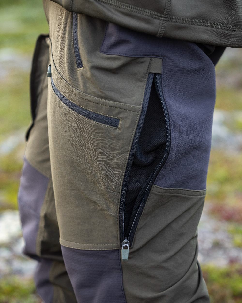 Moss Green Coloured Pinewood Mens Abisko Adventure Trousers on outdoor background #colour_moss-green