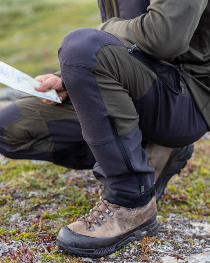 Moss Green Coloured Pinewood Mens Abisko Adventure Trousers on outdoor background #colour_moss-green