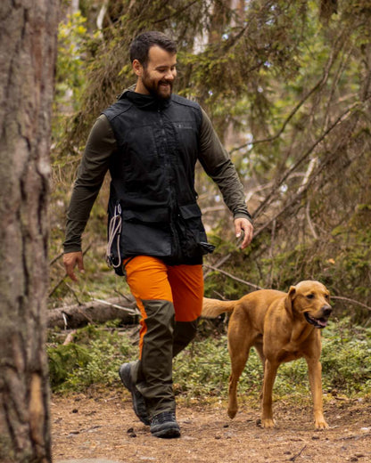 Burned Orange Mossgreen Coloured Pinewood Mens Abisko Brenton Trousers on outdoor background #colour_burned-orange-mossgreen