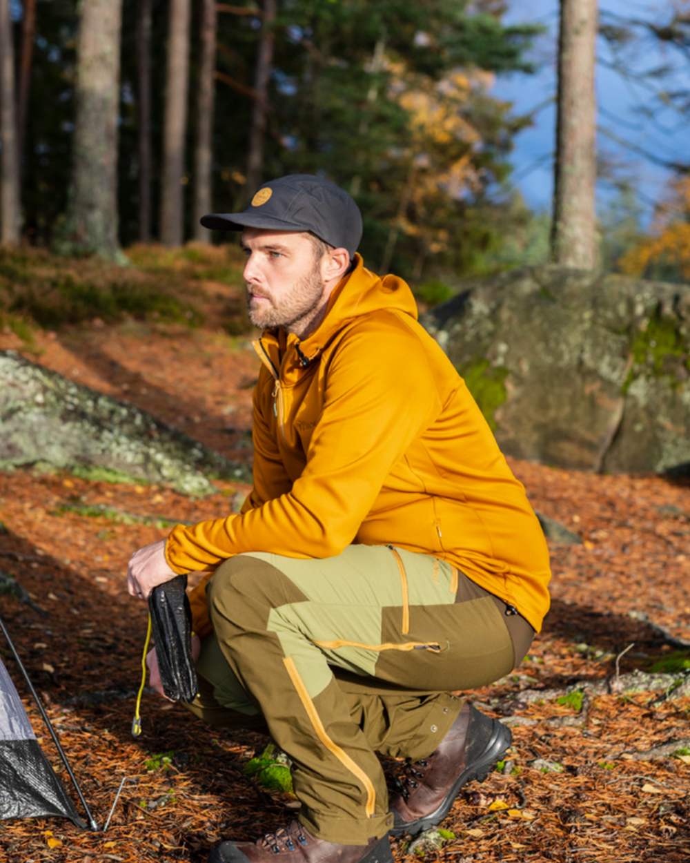 Leaf Hunting Olive Coloured Pinewood Mens Abisko Brenton Trousers on forest background #colour_leaf-hunting-olive