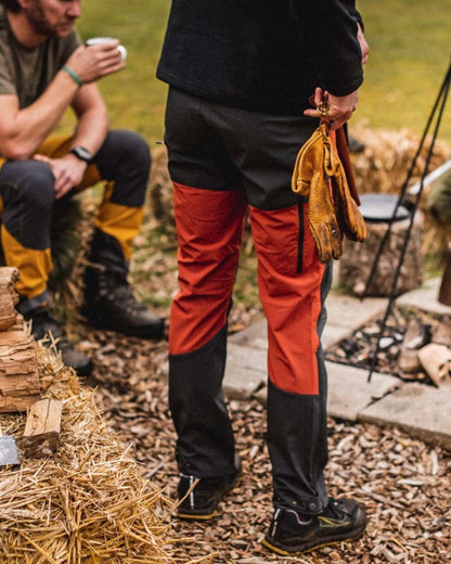 Terracotta Dark Anthracite Coloured Pinewood Mens Abisko Brenton Trousers on outdoor background #colour_terracotta-dark-anthracite