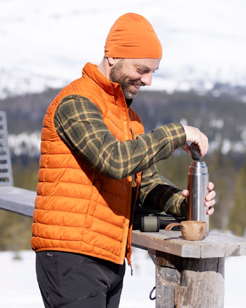 Burned Orange Coloured Pinewood Mens Abisko Insulation Vest on snow background #colour_burned-orange