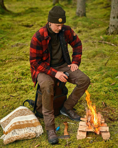 Suede Brown Dark Olive Coloured Pinewood Mens Caribou Hunting Trousers on outdoor background #colour_suede-brown-dark-olive