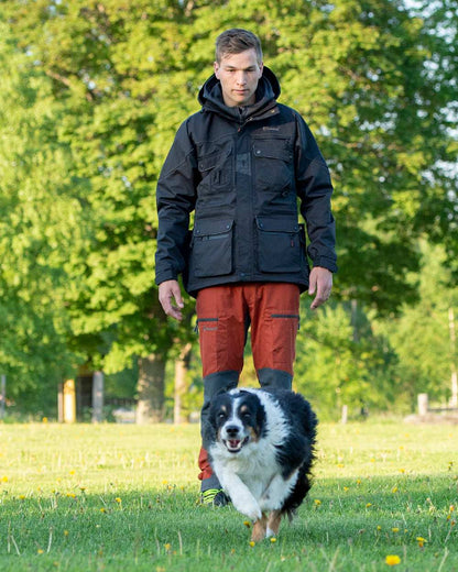 Terracotta Grey Coloured Pinewood Mens Caribou TC-Lite Trousers on outdoor background #colour_terracotta-grey