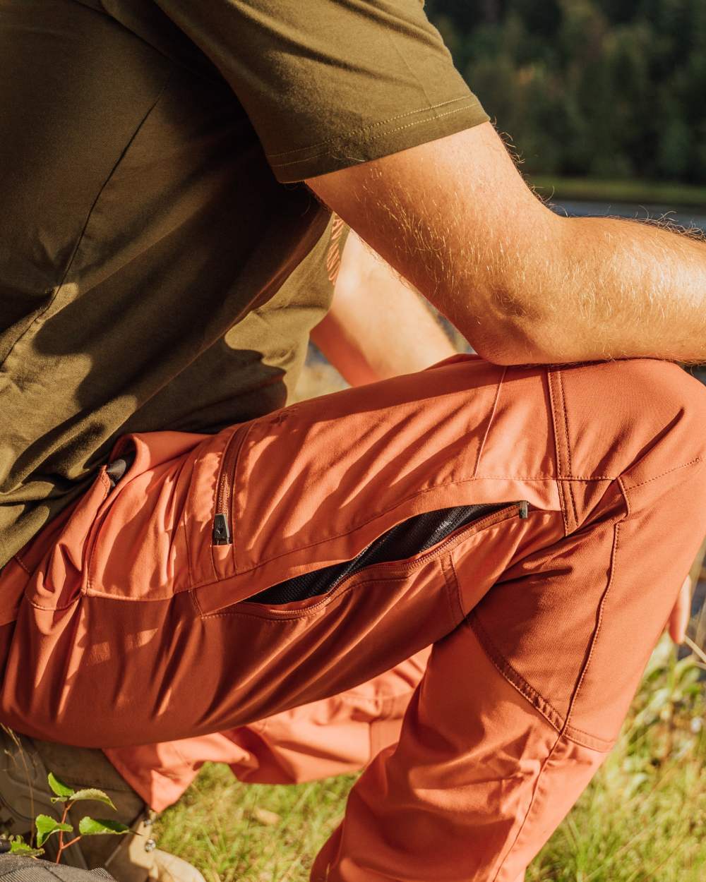 Burned Orange Terracotta Coloured Pinewood Mens Caribou TC Trousers on lake background #colour_burned-orange-terracotta