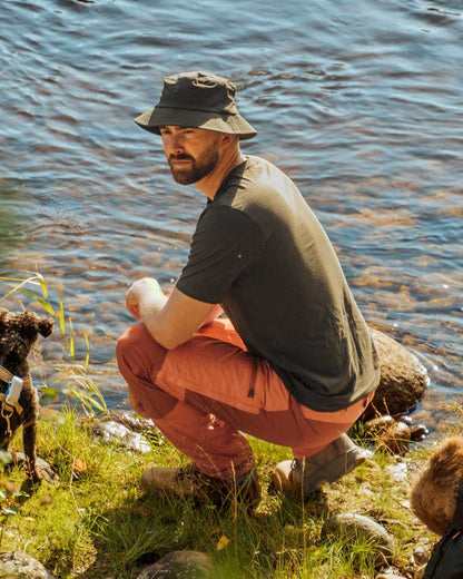 Burned Orange Terracotta Coloured Pinewood Mens Caribou TC Trousers on lake background #colour_burned-orange-terracotta