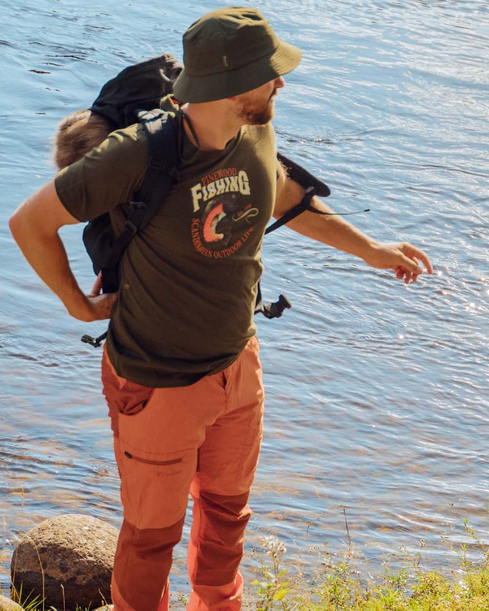 Burned Orange Terracotta Coloured Pinewood Mens Caribou TC Trousers on lake background #colour_burned-orange-terracotta