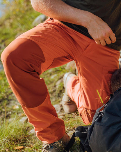 Burned Orange Terracotta Coloured Pinewood Mens Caribou TC Trousers on lake background #colour_burned-orange-terracotta