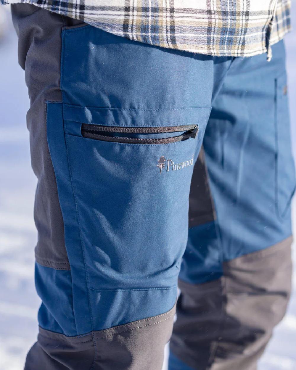 Dark Dive Dark Anthracite coloured Pinewood Mens Caribou TC Trousers  on blurry background #colour_dark-dive-dark-anthracite