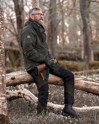 Moss Green Black Coloured Pinewood Mens Caribou Tc Extreme Trousers on forest background #colour_moss-green-black