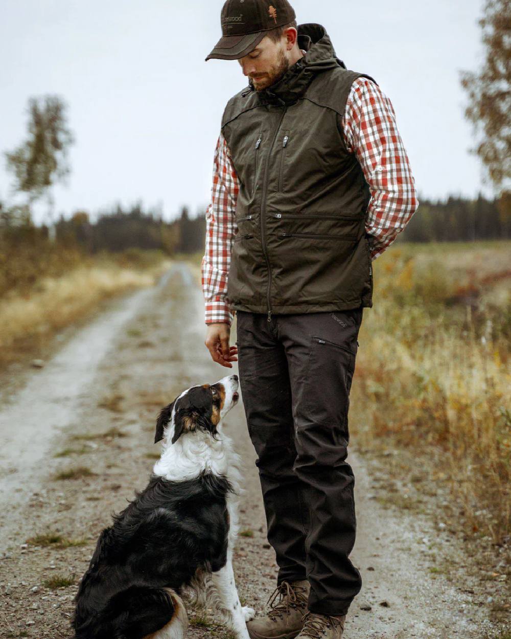 Moss Green coloured Pinewood Mens Dog Sports Windblocker Vest on grassy background #colour_moss-green