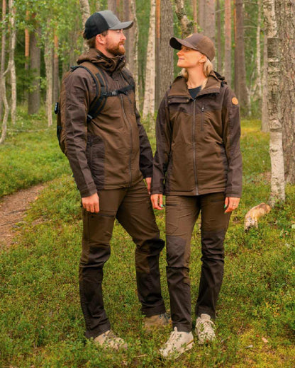 Dark Brown Coloured Pinewood Mens Finnveden Hybrid Jacket on outdoor background #colour_dark-brown
