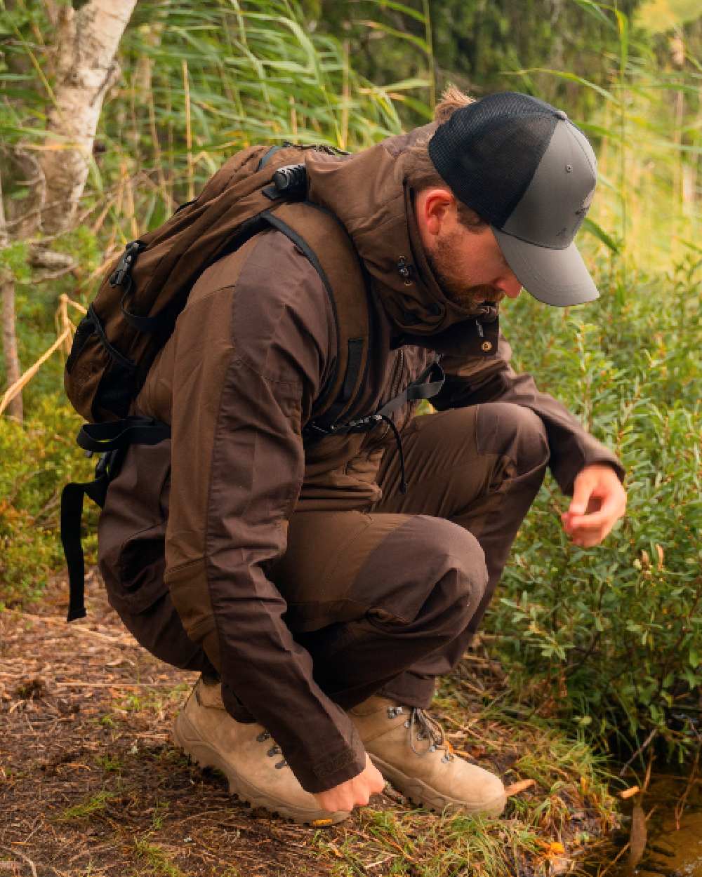 Dark Brown Coloured Pinewood Mens Finnveden Hybrid Jacket on outdoor background #colour_dark-brown