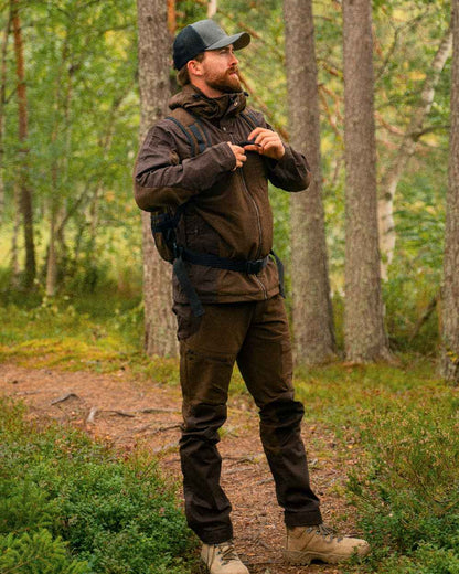 Dark Brown Coloured Pinewood Mens Finnveden Hybrid Jacket on outdoor background #colour_dark-brown