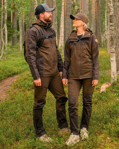 Dark Brown Coloured Pinewood Mens Finnveden Hybrid Trousers on outdoor background #colour_dark-brown