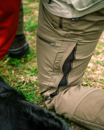 Hunting Olive Coloured Pinewood Mens Finnveden Hybrid Trousers on outdoor background #colour_hunting-olive