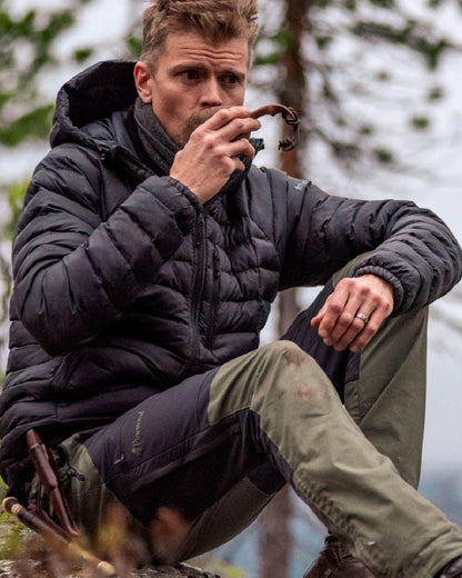 Mid Green Dark Anthracite coloured Pinewood Mens Finnveden Hybrid Trousers on forest background #colour_mid-green-dark-anthracite