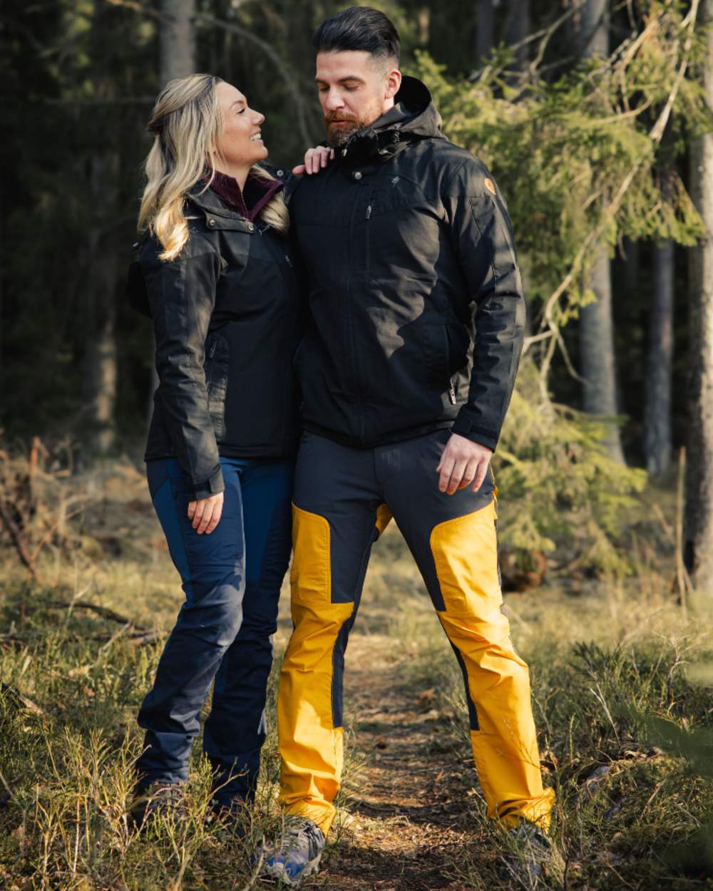 Black coloured Pinewood Mens Finnveden Hybrid Jacket on forest background #colour_black