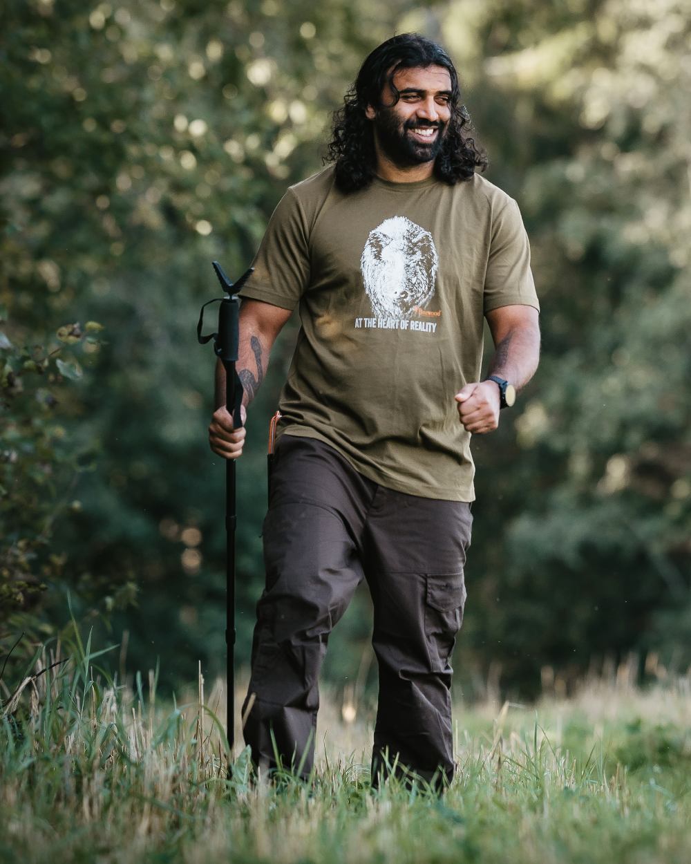 Dark Brown Coloured Pinewood Mens Finnveden Outdoor Trousers on forest background #colour_dark-brown