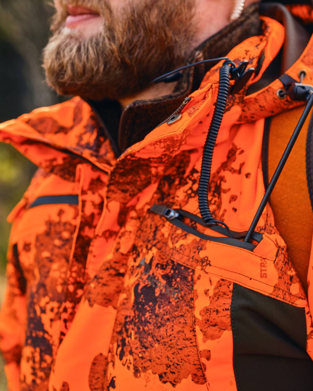 Strata Blaze Coloured Pinewood Mens Hunter Pro Xtreme 2.0 Camou Jacket on forest background #colour_strata-blaze