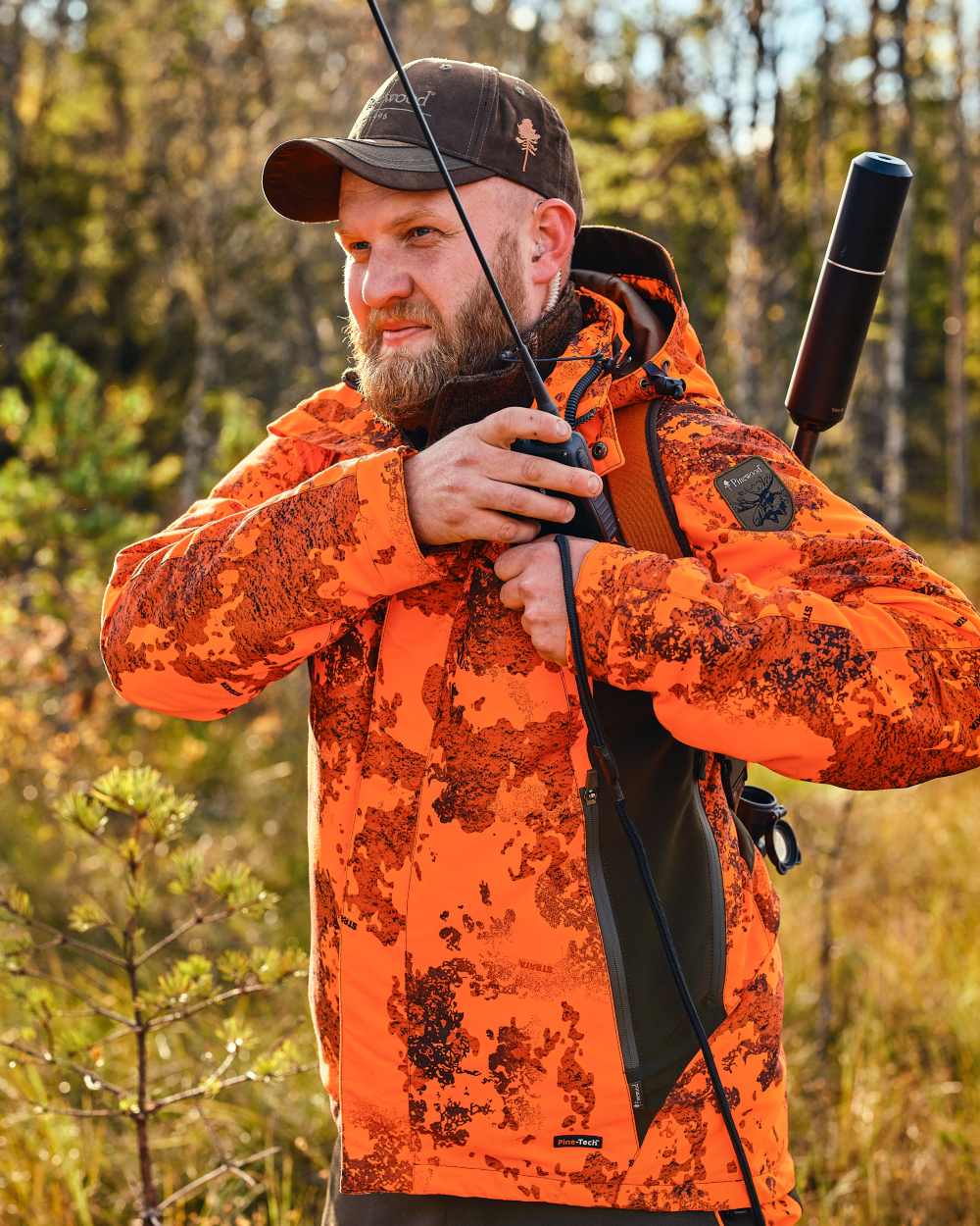 Strata Blaze Coloured Pinewood Mens Hunter Pro Xtreme 2.0 Camou Jacket on forest background #colour_strata-blaze