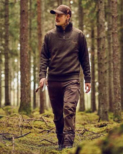 Dark Green Mel Coloured Pinewood Mens Hurricane Sweater on outdoor background #colour_dark-green-mel