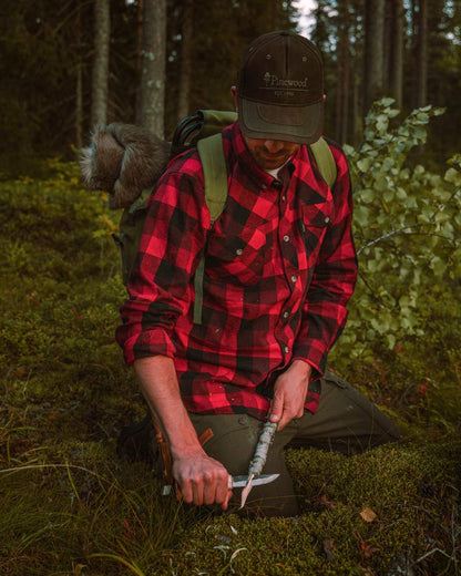 Red Black coloured Pinewood Mens Lumbo Shirt on forest background #colour_red-black