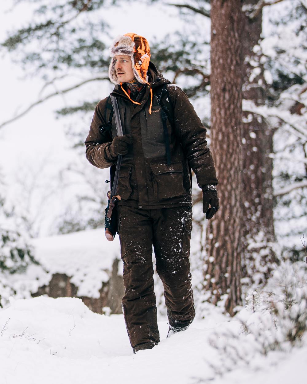 Suede Brown Coloured Pinewood Mens Smaland Abisko 2.0 Hunting Jacket on snow background #colour_suede-brown