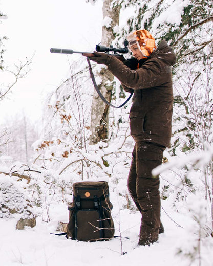 Suede Brown Coloured Pinewood Mens Smaland Abisko 2.0 Hunting Jacket on snow background #colour_suede-brown