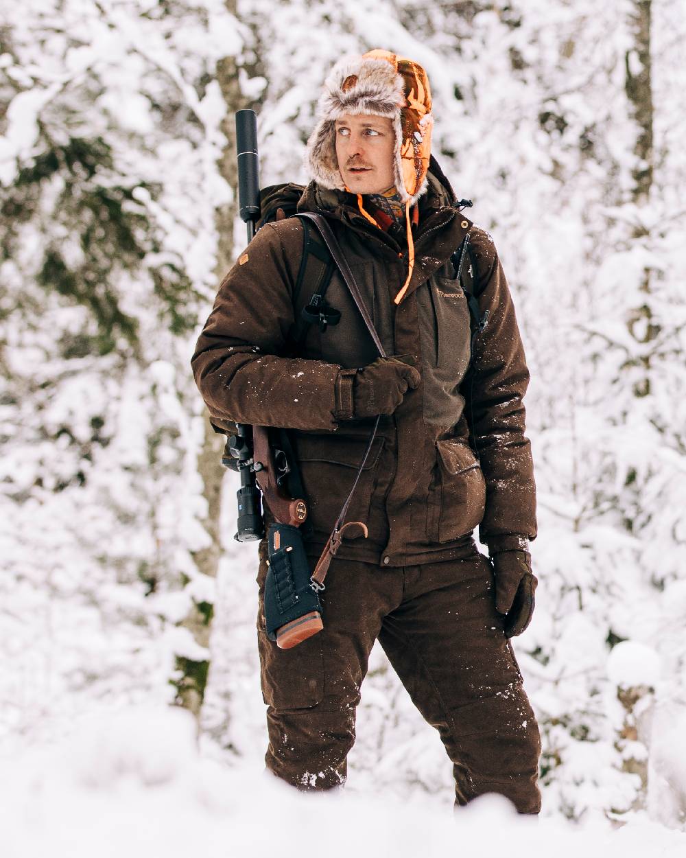 Suede Brown Coloured Pinewood Mens Smaland Abisko 2.0 Hunting Jacket on snow background #colour_suede-brown