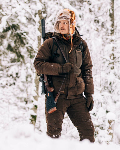 Suede Brown Coloured Pinewood Mens Smaland Abisko 2.0 Hunting Jacket on snow background #colour_suede-brown