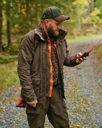 Suede Brown Coloured Pinewood Mens Smaland Hunters Jacket on forest background #colour_suede-brown
