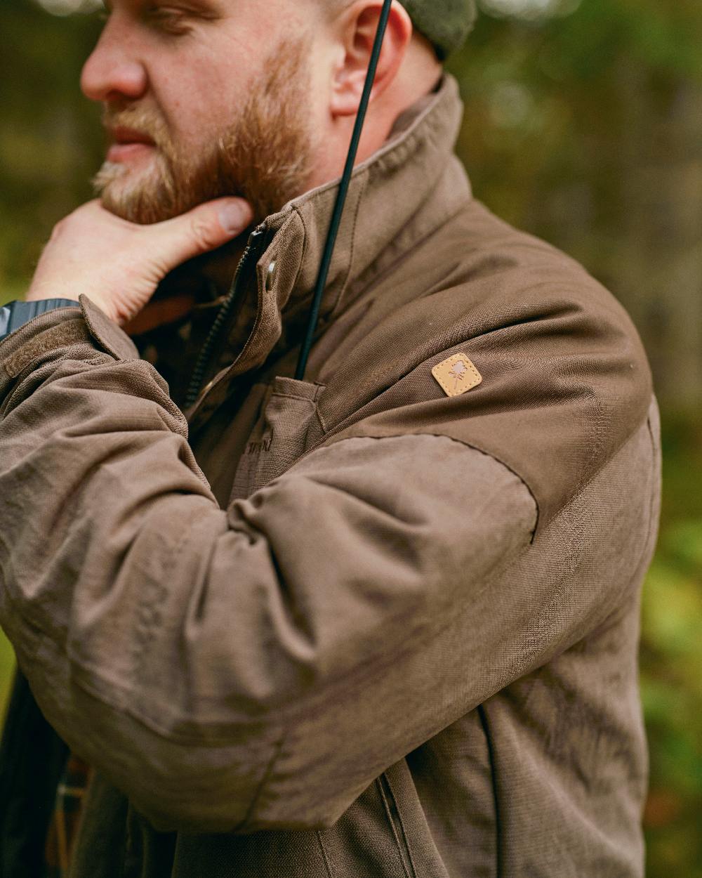 Suede Brown Coloured Pinewood Mens Smaland Hunters Jacket on forest background #colour_suede-brown