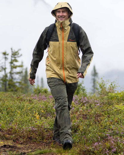 Moss Green Coloured Pinewood Mens Telluz Trousers on forest background #colour_moss-green
