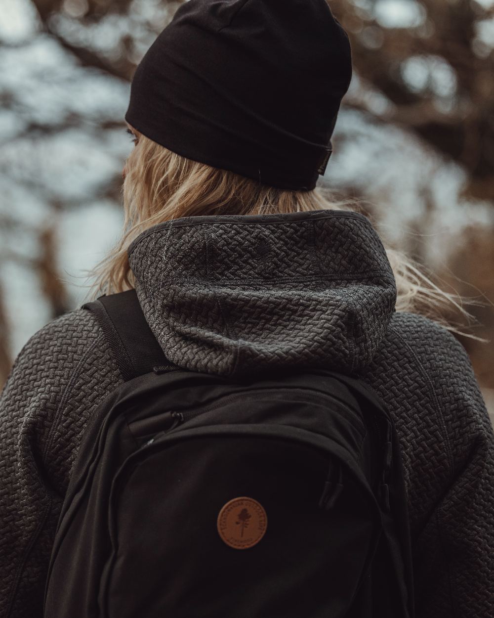 Black Coloured Pinewood Merino Wool Beanie on outdoor background #colour_black