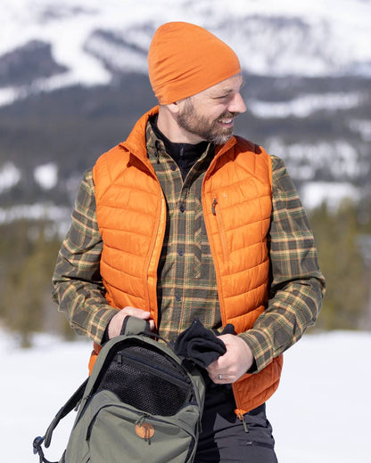 Burned Orange Coloured Pinewood Merino Wool Beanie on outdoor background #colour_burned-orange