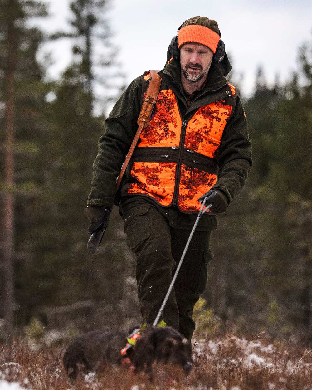 Mossgreen Orange Coloured Pinewood Smaland Reversible Hunters Hat on outdoor background #colour_mossgreen-orange
