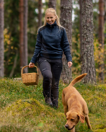 Black Coloured Pinewood Womens Abisko Adventure Trousers on forest background #colour_black
