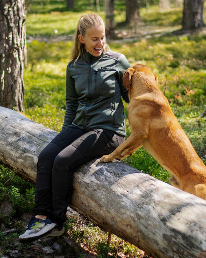 Black Coloured Pinewood Womens Abisko Adventure Trousers on forest background #colour_black